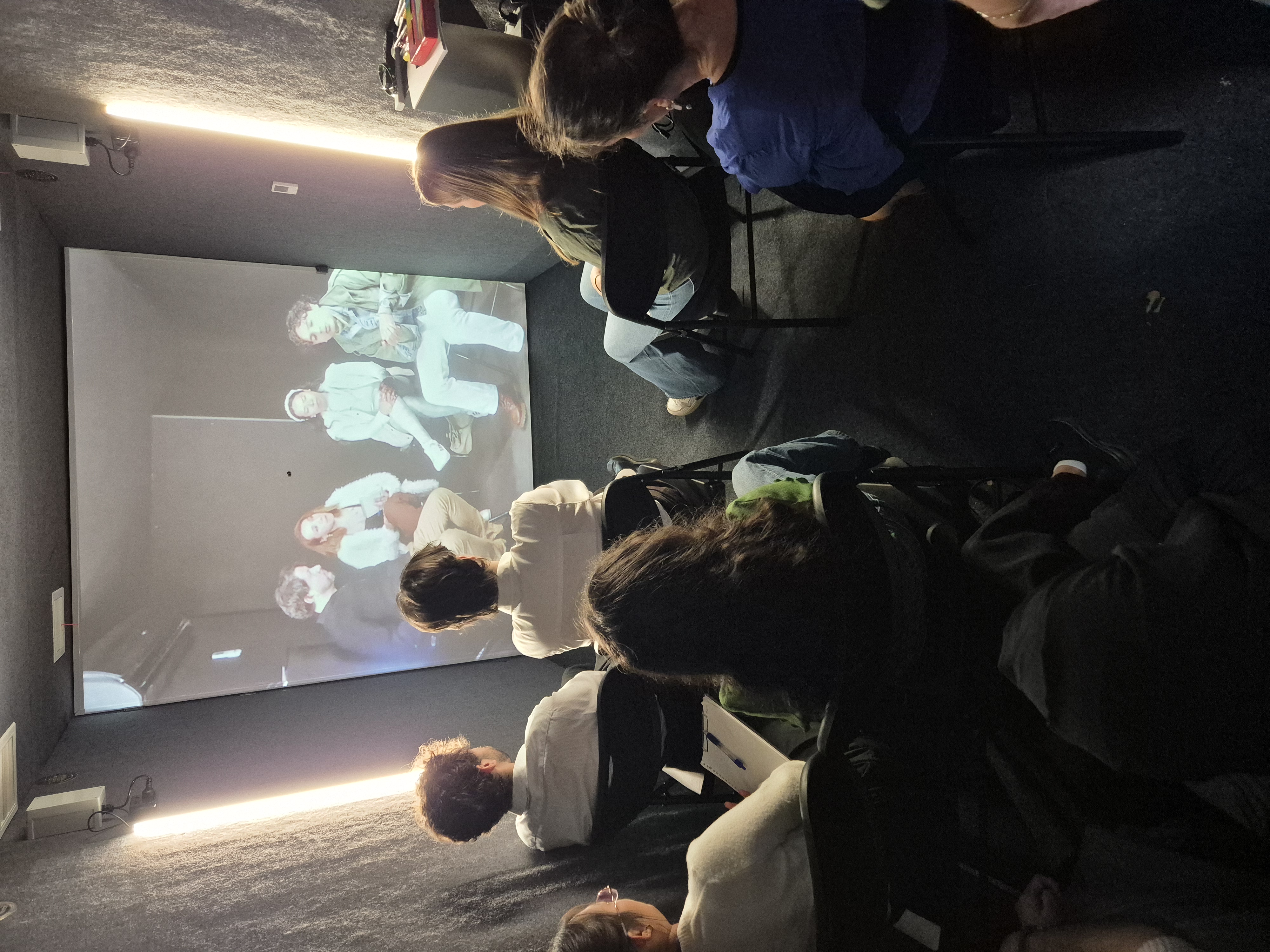 Students inside the global portal speaking with people in Mexico via a large screen