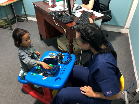 An Audiologist working with one child