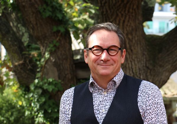 Head shot of Professor David Berlowitz standing in front of a tree 