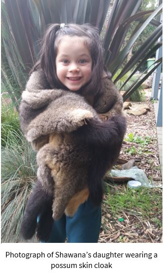 Photograph of child wearing possum skin cloak