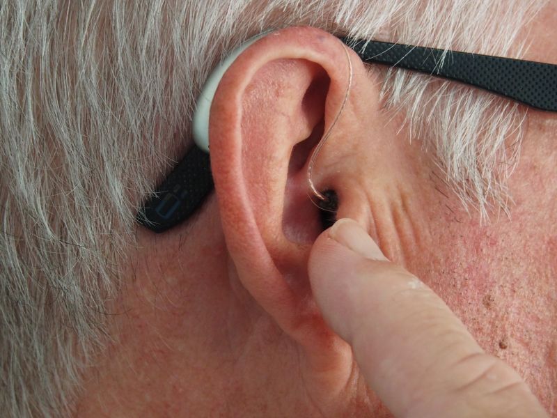 Pushing hearing aid into ear