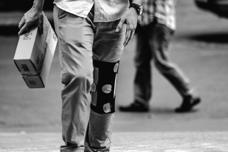 Man walking with knee brace