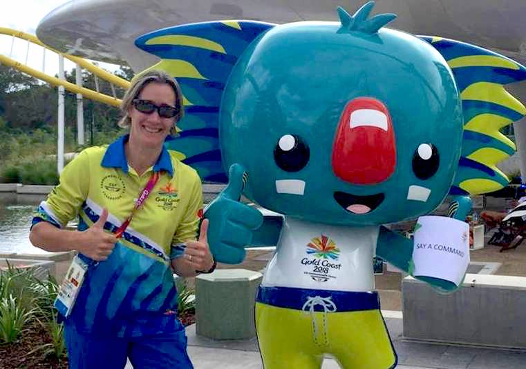 Dr Sonya Moore standing next to a statue of the 2018 Commonwealth Games Mascot, a green Koala named Borobi
