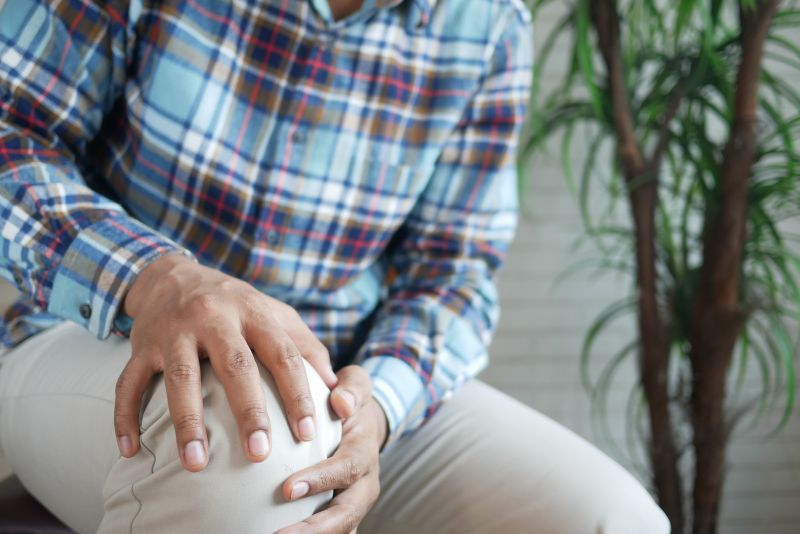 Person grabbing knee