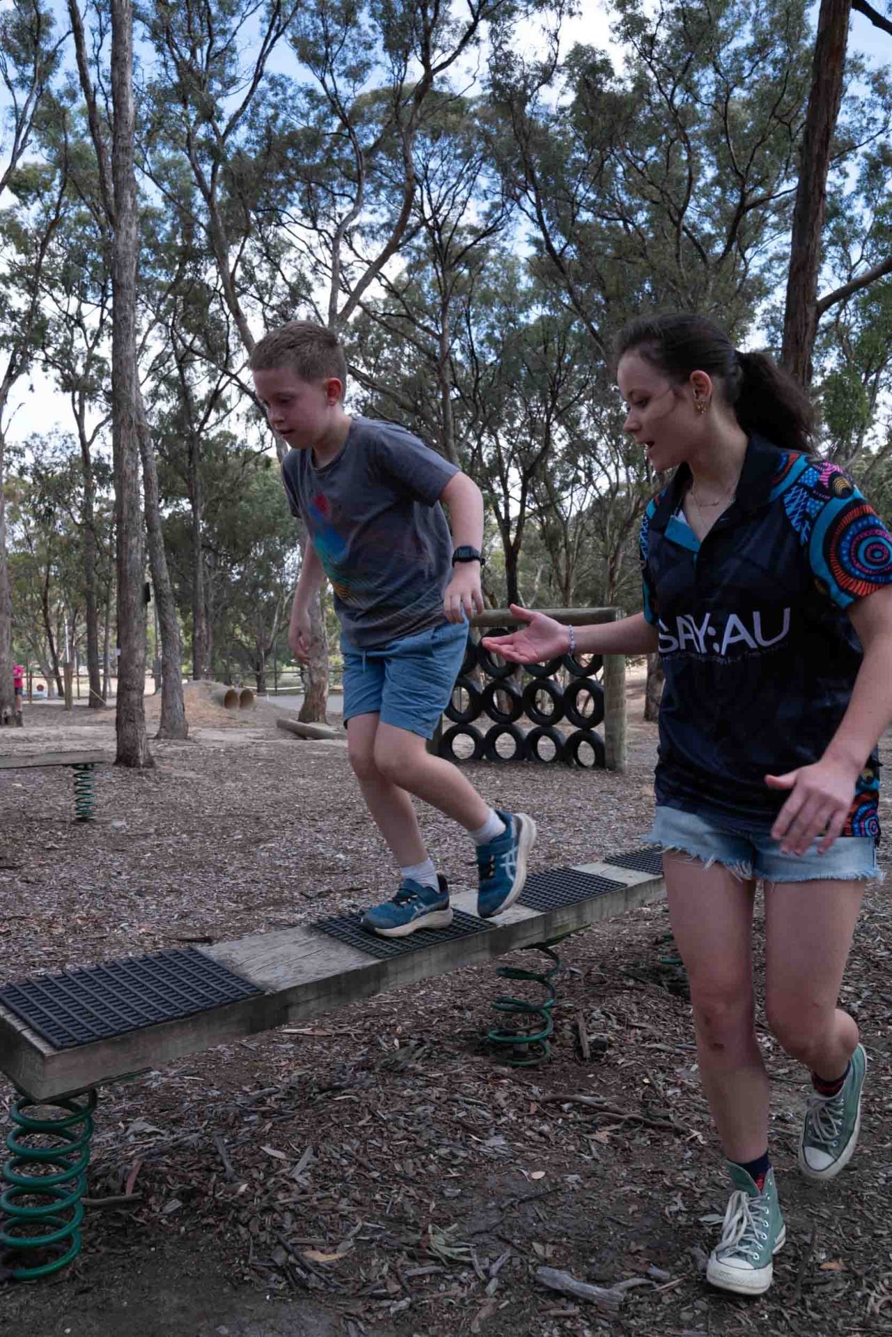 Outdoor camp obstacle course with camper